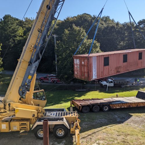 Lifting and moving containers with crane