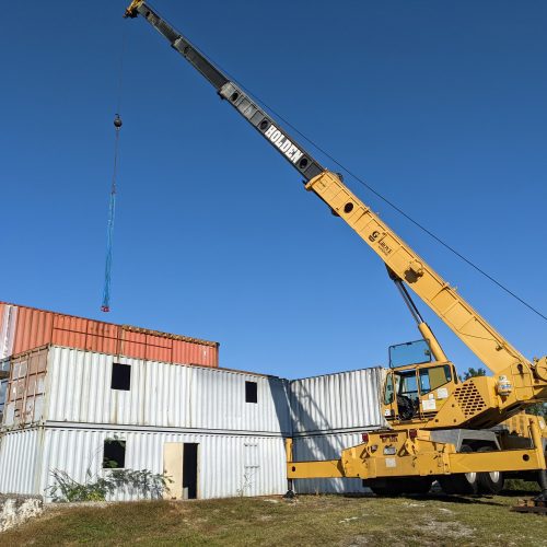 Lifting and moving containers with crane