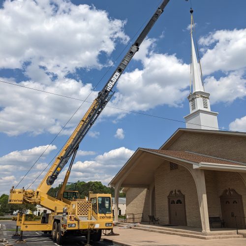 Removing steeple from church with crane for roofwork before reinstallation