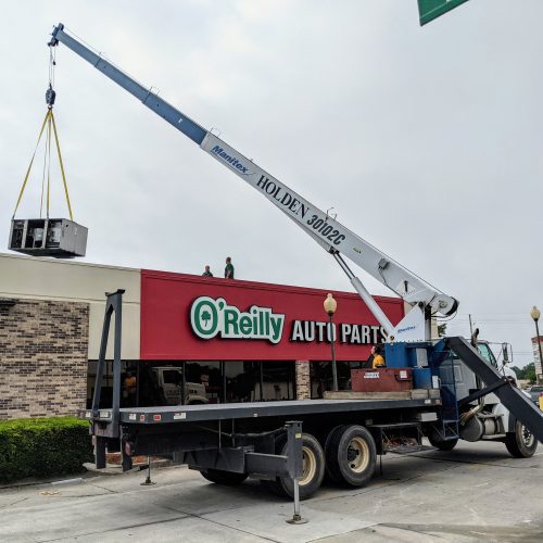 Boom truck removing and setting HVAC units on local O'Reilly store